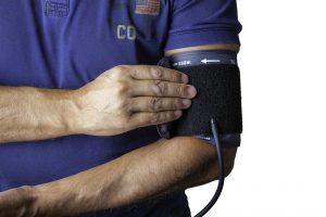 Man wearing blood pressure sleeve