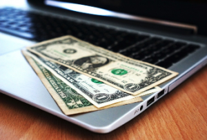 Laptop computer with dollar bills