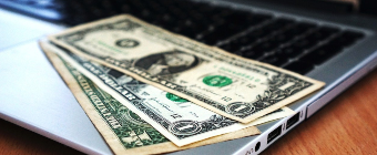 Laptop computer with dollar bills